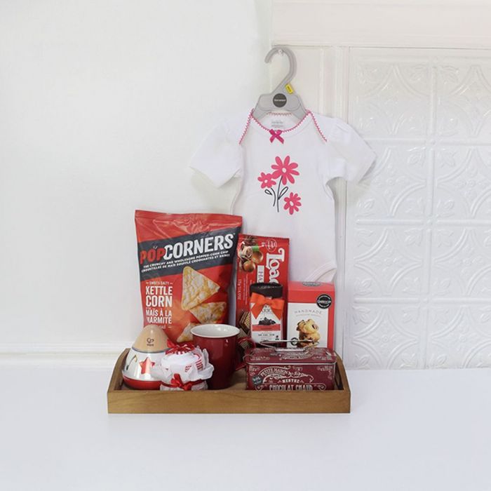 Baby Gift Basket Featuring Kushies Bodysuit, Music Box, and Gourmet Snacks – how the gift is presented